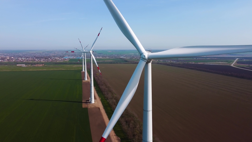 Aerial view of powerful Wind turbine farm for energy. Wind power turbines generating clean renewable energy. 4k footage.