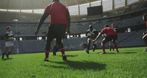 Animation of spots lights moving over diverse team of rugby players during game in field. sports, winning and competition concept digitally generated video.