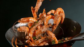 Super slow motion of flying whole prawns from wok pan. Filmed on high speed cinema camera, 1000 fps. - Powered by Shutterstock - Get 15% off with code: PIKWIZARD15