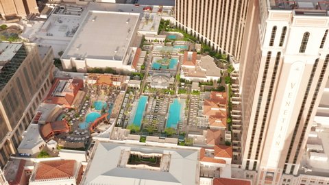 Cinematic pool area in famous hotel on Las Vegas Strip Nevada USA April 2022. Aerial view on bright blue pools in Venetian and Palazzo luxury 5-stars hotel resort and casino in Italian European style