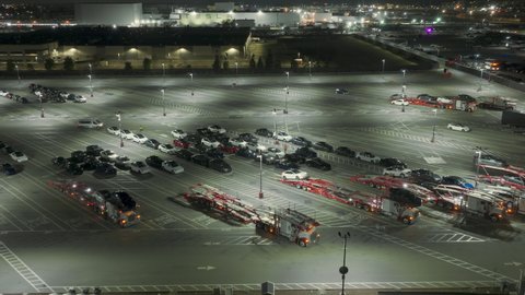 Tesla factory, Fremont, USA. Feb. 2022. Aerial footage of large parking lot for new energy efficient cars by the plant. Cars loading on a carriage after engineering testing. High quality 4k footage