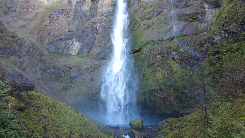 Multnomah Falls plunges over 500 feet from a cliff into the scenic Columbia River Gorge, Oregon. This narrow canyon, with the Columbia River flowing through it, separates Oregon and Washington.