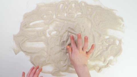child finger drawing in sand. Top view draw on sand. Caucasian kid hands write text in beige sand. Vacation and travel. Beach vacation. Sand painting. Creativity from natural materials. image. picture