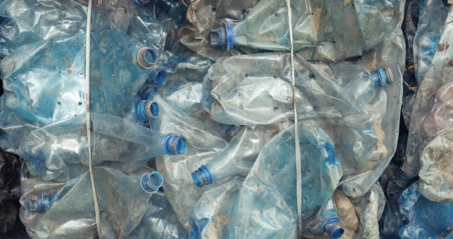 Plastic bottle collected waste pile, recyclable material, PET bottles collected into bales for recycling, MRF residual cubes | Shutterstock HD Video #1090029139