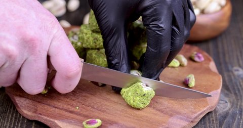 cut fresh Turkish delight with crushed pistachios and chocolate, fresh Turkish delight with green pistachios cut with a knife