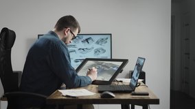 Industrial design studio with graphic tablet and computers. A senior designer draws a new car concept on a tablet. - Powered by Shutterstock - Get 15% off with code: PIKWIZARD15