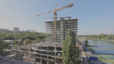 Construction of a multi-storey residential building. Tower crane at a construction site. Construction crane at a construction site