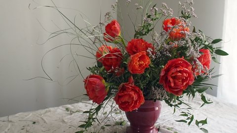 Lush whimsical flower arrangement with red flowers