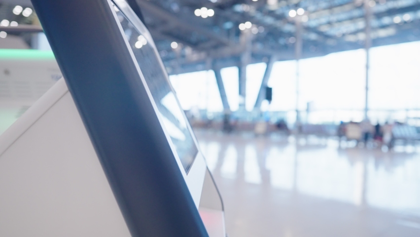 Passenger using smartphone scanning qr code on the ticket machine to check in for the flight at the airport terminal, less contact new normal technology, Screen scanner redeem ticket, online booking Royalty-Free Stock Footage #1090035327