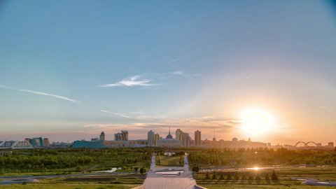 Panorama with beautiful sunset of the Astana city timelapse and the president's residence Akorda with park. View from the Palace of Peace and Reconciliation. Nur-Sultan city, Kazakhstan
