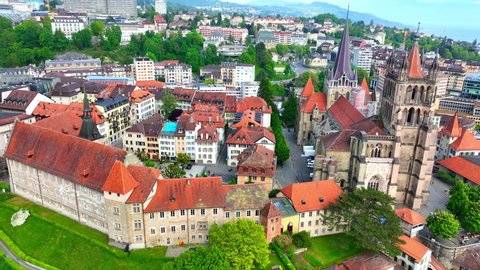 aerial view of Lausanne in Switzerland, capital of Swiss canton of Vaud, flying around medieval Lausanne cathedral, gothic protestant cathedral of Notre Dame in Lausanne. High quality 4k footage