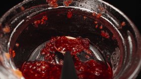 A jar of raspberry jam, I take out the jam with a spoon. Dolly slider extreme close-up inside. Laowa Probe