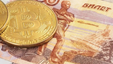 Bitcoin coins (new virtual money) on Russian banknotes A close up image of bitcoins with Russian rubles banknotes Bitcoin coin on the background of Russian rubles Bitcoin Russia Ruble Cryptocurrency