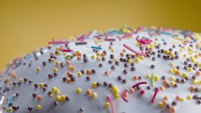 Easter cake decoration with colorful decorative sprinkles on yellow studio background. Homemade cake, christian festive bakery, tradition. Spring religious holiday  - Powered by Shutterstock - Get 15% off with code: PIKWIZARD15