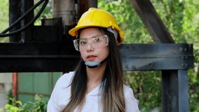 Asian female engineering worker with industrial wrench in workshop. Engineer woman working in manufacturing business. Profession and Construction Worker Concept - Powered by Shutterstock - Get 15% off with code: PIKWIZARD15