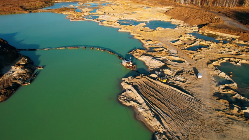 Aerial footage. Drone flies near machine for dredged river sand. Gold Dredge. Mining concept. Royalty-Free Stock Footage #1090044179