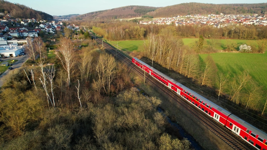 Aerial drone view of a train on the Deutsche bahn, spring, sunset in Hesse, Germany Royalty-Free Stock Footage #1090045681