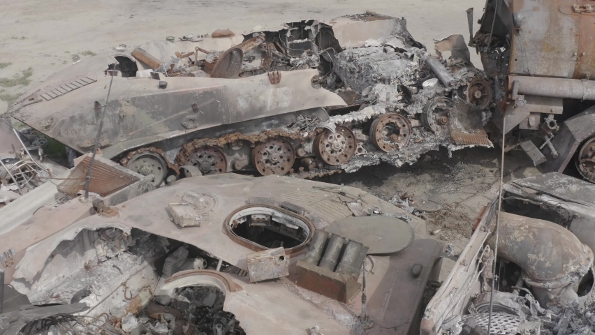 Destroyed military convoy. Burnt combat vehicles. Rusty tech. Consequences of an artillery strike. War in Ukraine. Bucha.