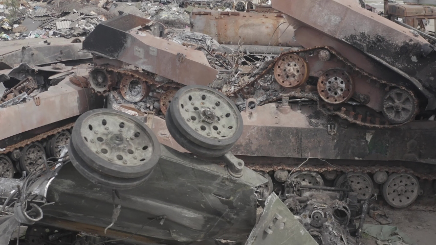 Destroyed military convoy. Burnt combat vehicles. Rusty tech. Consequences of an artillery strike. War in Ukraine. Bucha.