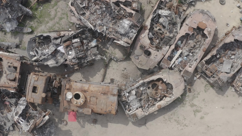 Destroyed military convoy. Burnt combat vehicles. Rusty tech. Consequences of an artillery strike. War in Ukraine. Bucha.
