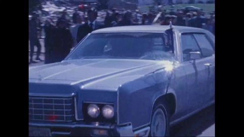 CIRCA 1974 - Crowds and photographers swarm President Nixon as he heads back to his car after touring tornado-struck Xenia, Ohio.