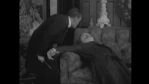 CIRCA 1916 - In this mystery movie, a man is killed by a booby trap while hunting for an artifact, whose owner he has just stabbed.