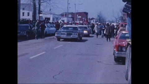 CIRCA 1974 - President Nixon's motorcade drives past debris-strewn streets in Xenia, Ohio, which was just hit by a tornado.
