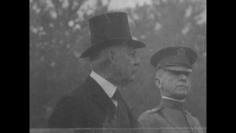 CIRCA 1920s - Secretary Weeks and General Summerall review a military parade, before President Coolidge gives a speech.