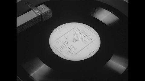 CIRCA 1942 - An FDR speech translated into French is played on a phonograph.