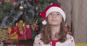 Beautiful Brazilian Girl, in Christmas clothes. wishing, cheering, crossing fingers, hopeful, Merry Christmas, New Year, 4K 60fps Premium cinematic video.
