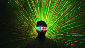The man in the interactive glasses on the laser beam background