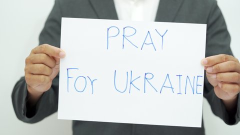 Person holds in hand Pray save for Ukraine concept. protect world peace from war