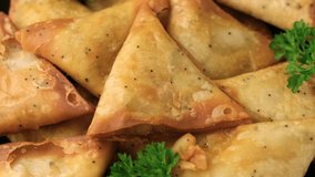 Fried samosas with vegetable filling, popular Indian snacks. Rotating video