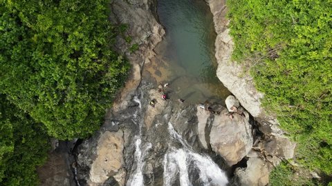 Beautiful waterfall in green forest, top view. Tropical in mountain jungle. Waterfall in the tropical forest. Big Waterfall taken by drone