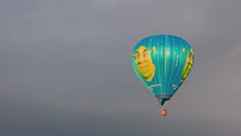 Beautiful view of Shrek hot air balloon in stormy cloudy sky.  Sweden. Uppsala. 05.09.2022.