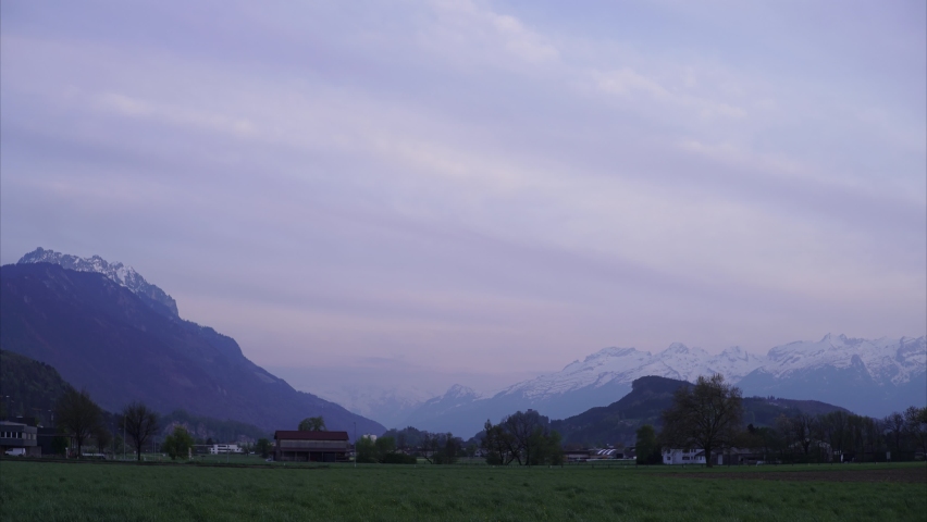 Timelapse of the transition from day to night in the mountains, sunset in swiss alps, evening in the mountains