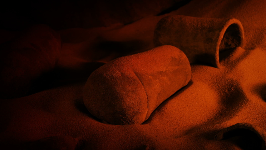 Stone Jar Is Picked Up From Cave Floor In Firelight
