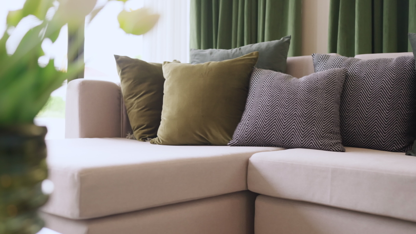 Home interior design detail of Modern clean living room with soft and cozy sunlight pillow upholsty curshion arrange on white sofa dolly shot close up,home sweet home background | Shutterstock HD Video #1090065103