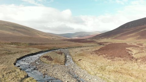 Flying over moorland river drone footage
