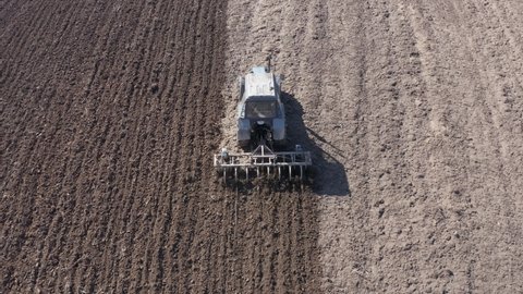 aerial view of a tractor that plows the land for sowing. Spring plow.