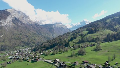 Stunning drone footage of Alpine Mountains, forests and waterfalls. Chalets nestle in the beautiful landscape near Sixt fer Cheval in the French alps.