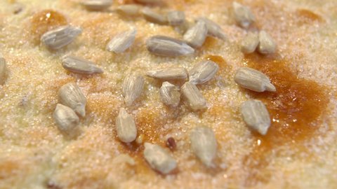 Pita bread with sunflower seeds. Sugary flatbread texture close up. Macro. Rotation