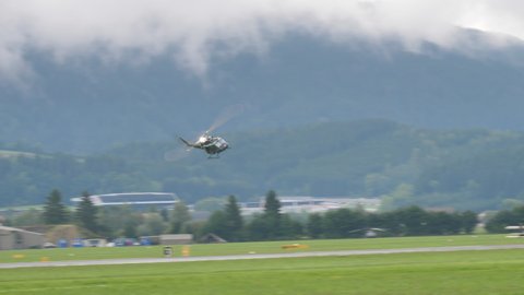 Zeltweg, Austria SEPTEMBER, 6, 2019 Vietnam War-era military helicopters stop in flight and launch ropes from which soldiers drop. Agusta Bell AB 212 UH-1N Twin Huey of Austrian Air Force Bundesheer