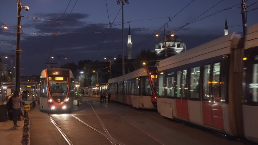 Istanbul, Turkey - September 15, 2021: Low-floor trams are passing the Beyazit Square area of Fatih District in evening. The Istanbul Tram is modern tram system on the European side of the city.