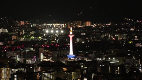 KYOTO, JAPAN - DECEMBER 2021 : Aerial high angle view of Kyoto city at night. Scenery of streets and buildings around Kyoto station. Time lapse shot. Japanese urban nightlife city concept video.