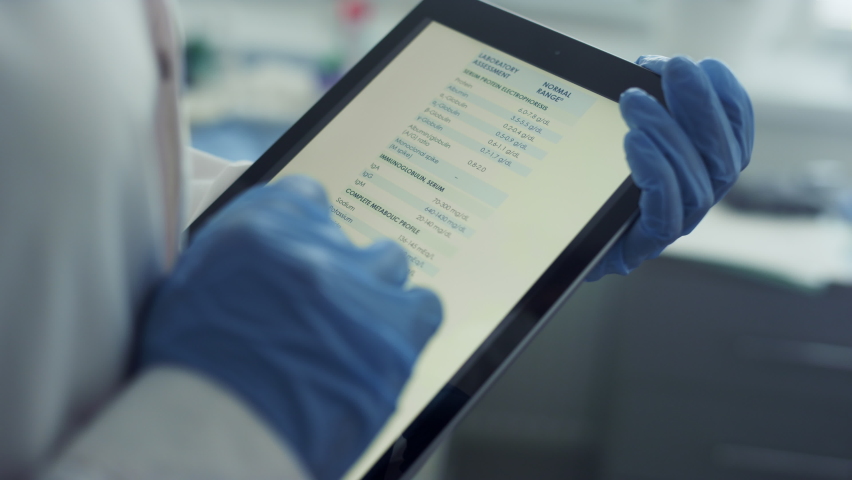 Doctor hands using tablet checking health history data in clinic office close up. Unknown physician magnifying image tables watching vaccination results on pad screen. Modern technologies in hospital. Royalty-Free Stock Footage #1090074583
