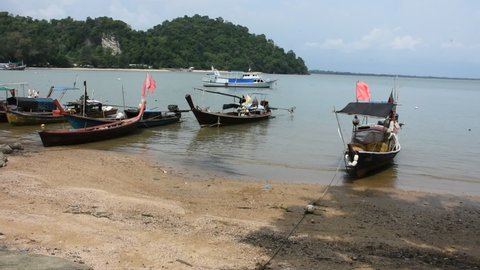 View landscape and local thai fisher people floating stop wooden boat ship in sea waiting catch fish in ocean of Mu Ko Petra National Park at Pak Bara fishing village at La ngu city of Satun, Thailand