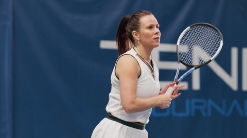 Female Tennis Player Hitting Ball with a Racquet During Championship Match. Professional Woman Athlete Successfully Receives Strike. World Sports Tournament. Slow Motion Medium Shot Playback