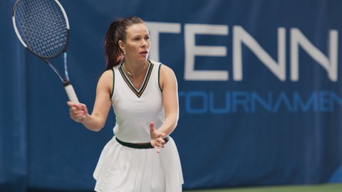 Female Tennis Player Hitting Ball with a Racquet During Championship Match. Professional Woman Athlete Successfully Receives Strike on Court. World Sports Tournament. Slow Motion Medium Shot Playback