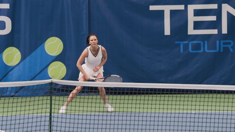 Tennis Championship Match Sports TV Broadcast. Female Tennis Player Serving Ball with a racquet, Finishes Set on Professional Tournament. Channel Network Television Broadcasting. 50 FPS Playback